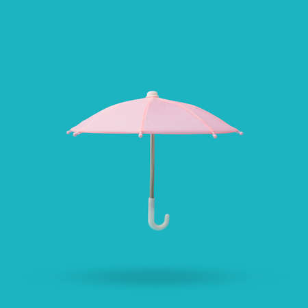 Pink umbrella with metal and plastic handle on a blue background.の写真素材
