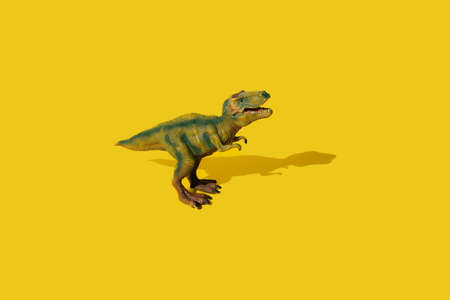 Dinosaurs Tyrannosaurus rex on a yellow background. T-rex toy.の写真素材