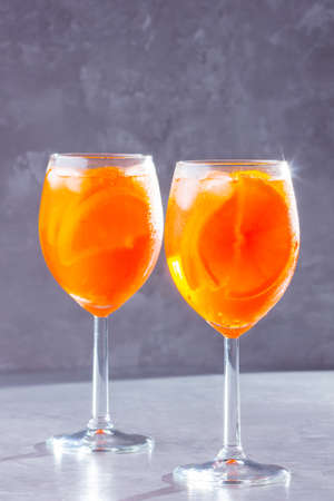 cocktail on gray background. Two glasses of with orange sliced. Summer cocktail in glass. Copy spaceの写真素材