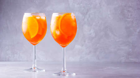 cocktail on gray background. Two glasses of  with orange sliced. Summer cocktail in glass. Copy spaceの写真素材