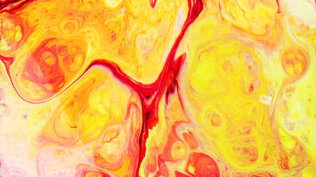 Fluid Art. Abstract blurred colorful background. Swirl liquid pattern. Marble effect of yellow red color. Trendy colorful backdropの写真素材