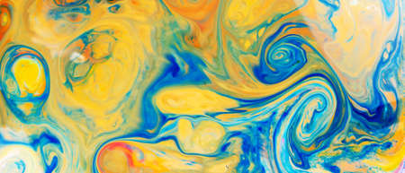 Fluid Art. Abstract blurred colorful background. Swirl liquid pattern. Marble effect of blue yellow color. Trendy colorful backdrop. Mixing paintsの写真素材