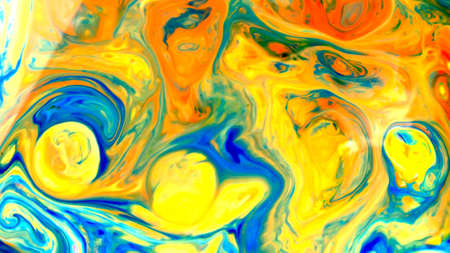 Fluid Art. Abstract blurred colorful background. Swirl liquid pattern. Marble effect of blue yellow color. Trendy colorful backdrop. Mixing paintsの写真素材