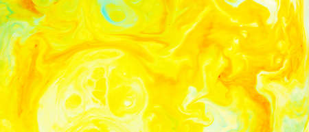 Fluid Art. Abstract blurred colorful background. Swirl liquid pattern. Marble effect of yellow color. Trendy colorful backdrop. Mixing paintsの写真素材