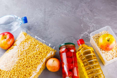 Food donations on a gray background. Food supplies. Top view. Copy spaceの写真素材