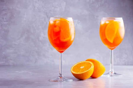 Orange cocktail on a gray background. Summer italian cocktail in glass. Copy spaceの写真素材