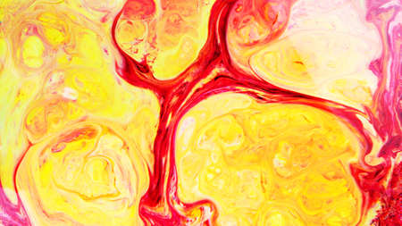 Fluid Art. Abstract blurred colorful background. Swirl liquid pattern. Marble effect of yellow red color. Trendy colorful backdropの写真素材