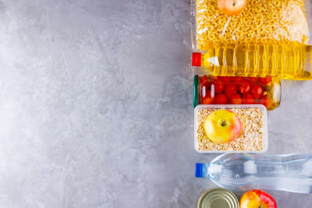 Food donations on a gray background. Food supplies. Coronavirus and quarantine concept. Top view. Copy spaceの写真素材