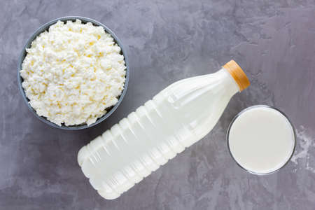 Various dairy products. Healthy dairy products on a gray background. Milk, sour cream and cottage cheese. Top view. Copy spaceの写真素材
