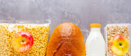 Food donations on a gray background. Food supplies. Set of food products. Top view. Copy spaceの写真素材