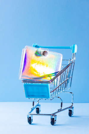 Shopping cart with school supply. School notepad with holographic cover. Purchase of school supplies for training. Back to school conceptの写真素材