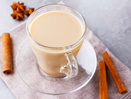 Masala chai tea. Traditional indian drink - masala tea with spices on gray background. Top viewの写真素材