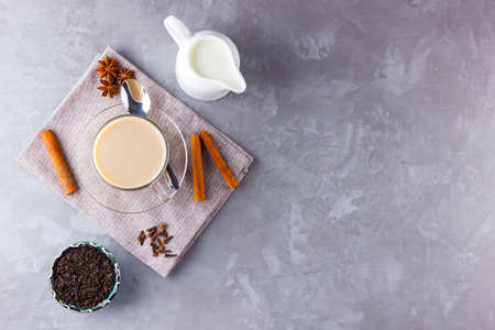 Masala chai tea. Traditional indian drink - masala tea with spices on gray background. Copy space. Top viewの写真素材