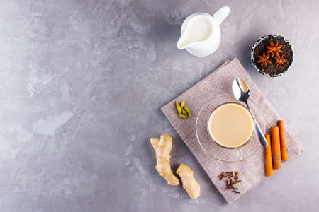 Masala chai tea. Traditional indian drink - masala tea with spices on gray background. Copy space. Top viewの写真素材
