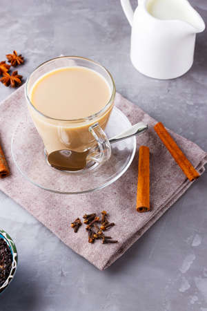 Masala chai tea. Traditional indian drink - masala tea with spices on gray background. Top viewの写真素材