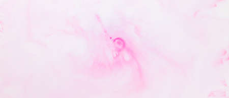 Fluid art texture. White pink background from liquid. Photography of colored spots on liquid. Abstract pattern for designの写真素材