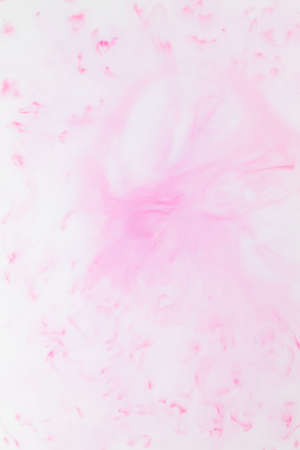 Fluid art texture. White pink background from liquid. Photography of colored spots on liquid. Abstract pattern for designの写真素材