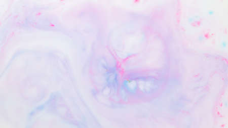 Fluid art texture. Pink blue background from liquid. Photography of colored spots on liquid....