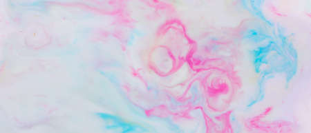 Fluid art. Multicolored background from liquid. Photography of colored spots on liquid. Abstract patternの写真素材