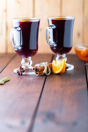 Mulled wine on a wooden boards. Autumn mulled wine, spices and honey. Christmas hot drink in rustic styleの写真素材