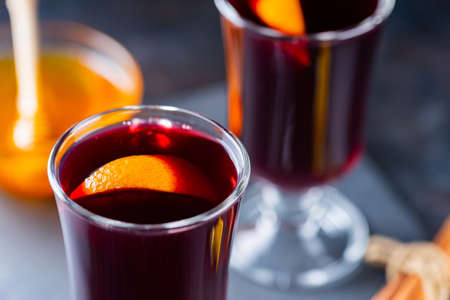 Mulled wine on a slate board. Two glasses of hot mulled wine and ingredients. Christmas hot drink with wine and honeyの写真素材