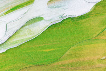 Abstract glitter paints texture on canvas. Background with glittering paints. Macro close up of...