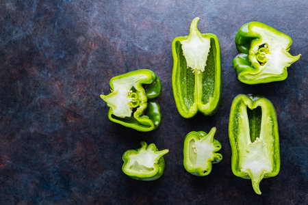 Ugly bell pepper on dark background. Sliced bell pepper halves on the table. Concept - reduction of food organic waste. Non GMO vegetables. Copy space. Top viewの写真素材