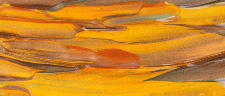 Orange brown background with glittering smears. Abstract paint texture. Creative brushstrokes of...
