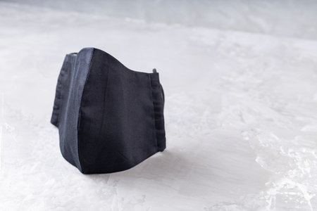 Face protective mask on ultimate gray background. Antivirus mask made from black cotton. Black face homemade mask to protect against flu and virus. Copy space. Top viewの写真素材