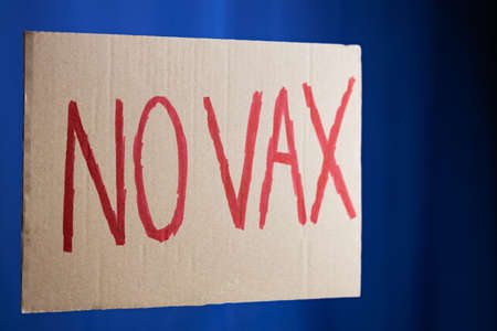 Anti vaccination protestive placard on a blue background. No vax conceptの写真素材