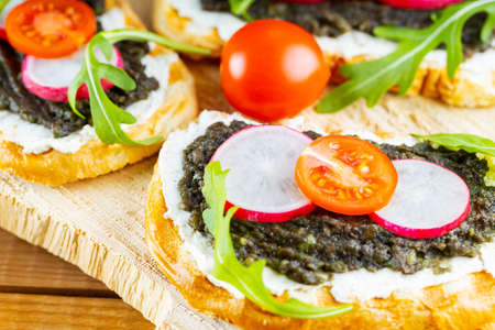 Vegan sandwiches with avocado cream. Healthy sandwiches with cream cheese, avocado, radish and...