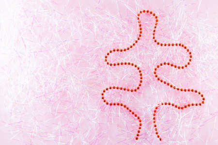 Symbol Christmas and Happy New Year figure christmas tree with red beads on tinsel. Christmas beads...