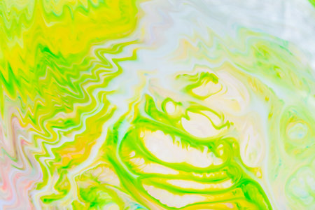 Abstract yellow-green liquid background. Green paint pattern with cyclical swirls. Trendy wallpaper....