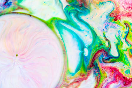 Multicolored lines and spots on liquid surface. Abstract background made with fluid art technique. Trendy colorful backdrop. Fluid artの写真素材