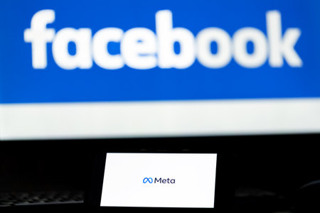 Kyiv, Ukraine - October 29, 2021: Facebook changes name to Meta. Smartphone with Meta logo on the background on logo Facebook. New name Facebook, re branding conceptのeditorial素材