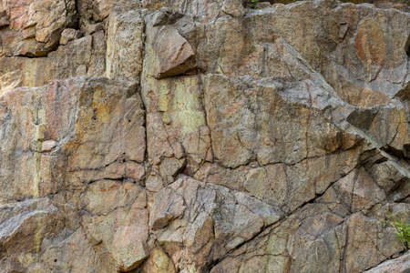 Destruction of the rock of the mountain after the explosion. Cracks in the granite rock due to human...