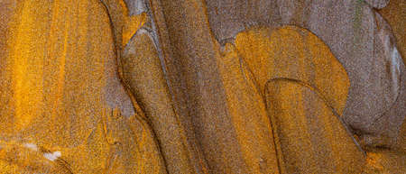 Golden background of oil paint strokes. Surface of brown-orange sparkling paints. Golden bronze...