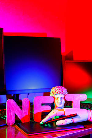 NFT (Non-Fungible token). Artificial hand creates crypto art using a graphics tablet. Gypsum copy of...