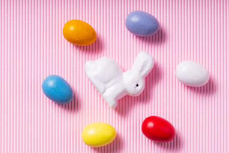 Easter eggs and white bunny. Easter decorations on a pink pastel background. top viewの写真素材