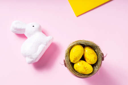Easter eggs and white rabbit on a pink background. easter concept