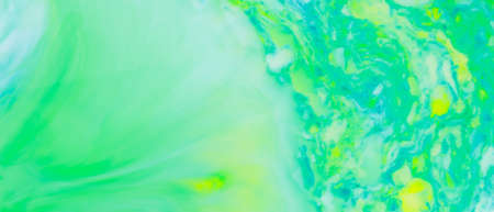 Fluid art creative background. Turquoise yellow spots on liquid. Abstract background with multi-colored stains. Chaos conceptの写真素材