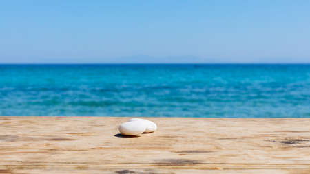 Wood table top on blur summer blue sea. Empty wooden table on the seashore and blue sky. Concept of...