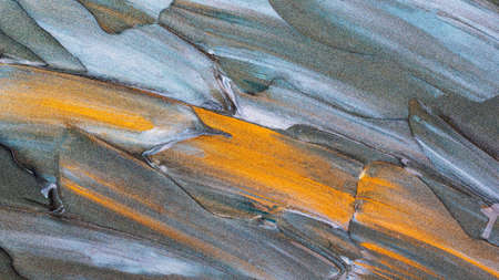 Blue-green glitter texture background. Creative brushstrokes of glitter gold paint. Sparkling surface of blue-green paint strokes with a dash of gold paintの写真素材