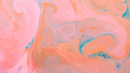 Peach coral color background. Fluid art texture with coral color. Abstract background with multicolored spots on liquidの写真素材