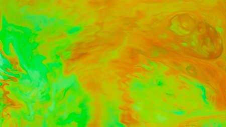 Abstract green-orange fluid art background. Backdrop with abstract mixing paint effect. Liquid surface with blurry paint spotsの写真素材