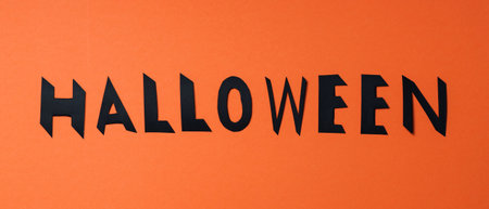 Halloween lettering with black letters on an orange background. Halloween background. copy spaceの写真素材