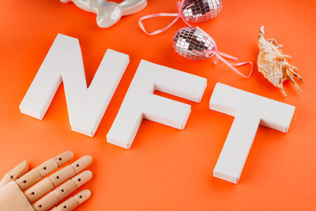 NFT on orange background. Non-Fungible Token in creative surreal style. Concept of NFT creation by artificial intelligenceの写真素材