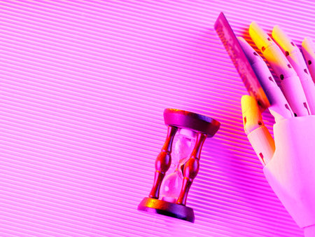 Bank card in an artificial hand. Credit card and hourglass in neon light. Time is money concept....