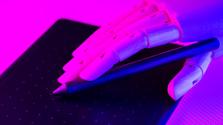 Artificial arm works on a graphics tablet. Creating graphic design with artificial intelligence....