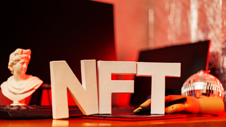 NFT inscription and artificial hand at the designer's workplace. Non-Fungible token lettering in neon light. Futuristic cryptocurrency conceptの写真素材